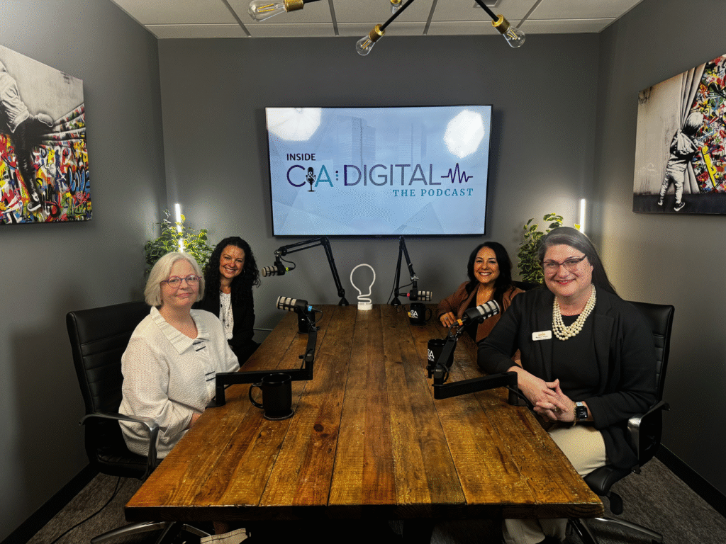 A group of nonprofit leaders sit around a table while filming Inside C&A Digital: The Podcast