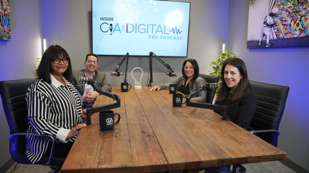 A group of marketers sit around a table while filming Inside C&A Digital: The Podcast